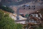 BNSF 7912 peaks her nose out as she rounds the bottom end of a curve rolling west/south towards San Bernardino, Ca with the I-15 as the backdrop.